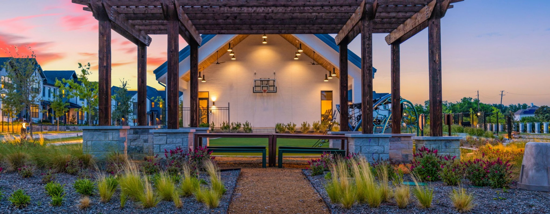 a pergola with seating and landscaping