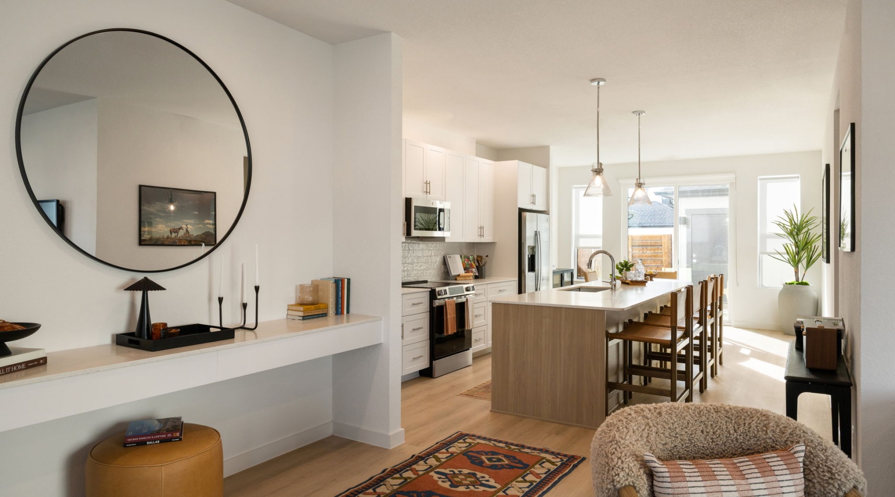  a four bedroom townhome foyer open to a large kitchen and living room with ample light and large windows at a build-to-rent community