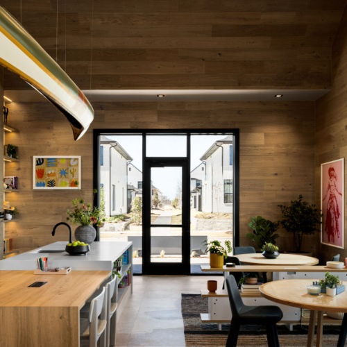 the resident clubhouse lounge with tables at a build-to-rent community