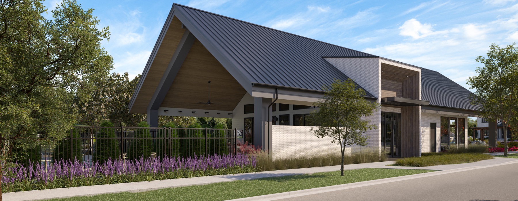 Large amenity building with lush landscaping.